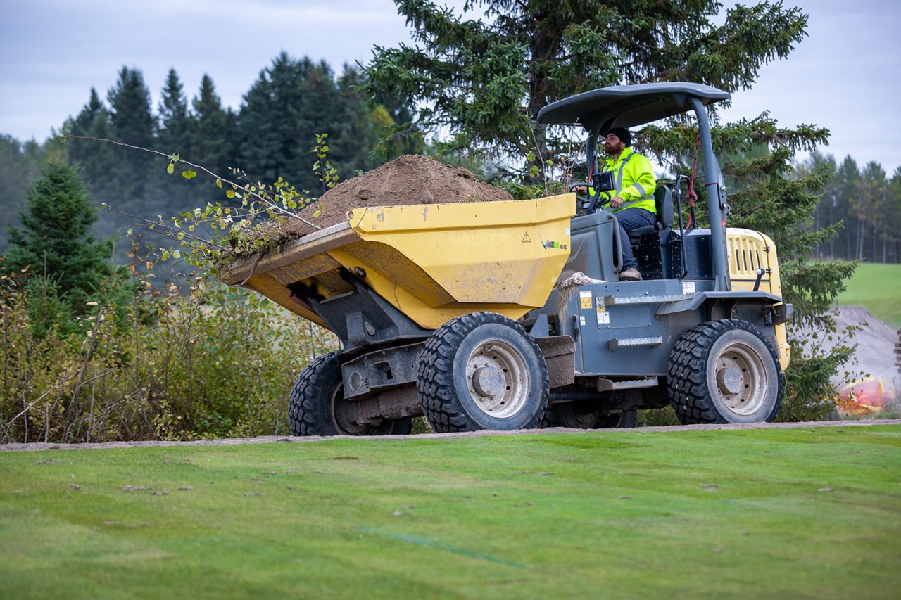 Large tractor carrying soil.